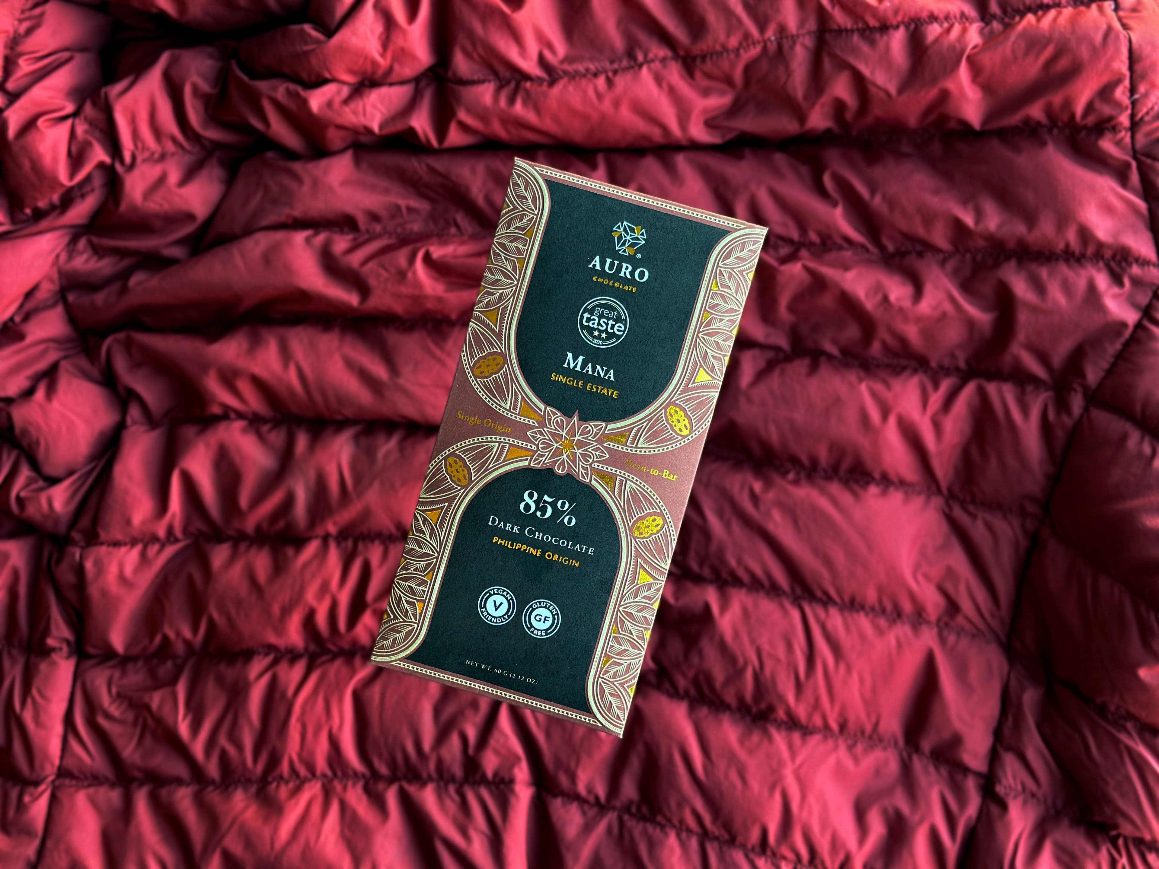85% Dark Chocolate Mana Single-Estate bar made by Auro Chocolate in the Philippines on a red ruffled background