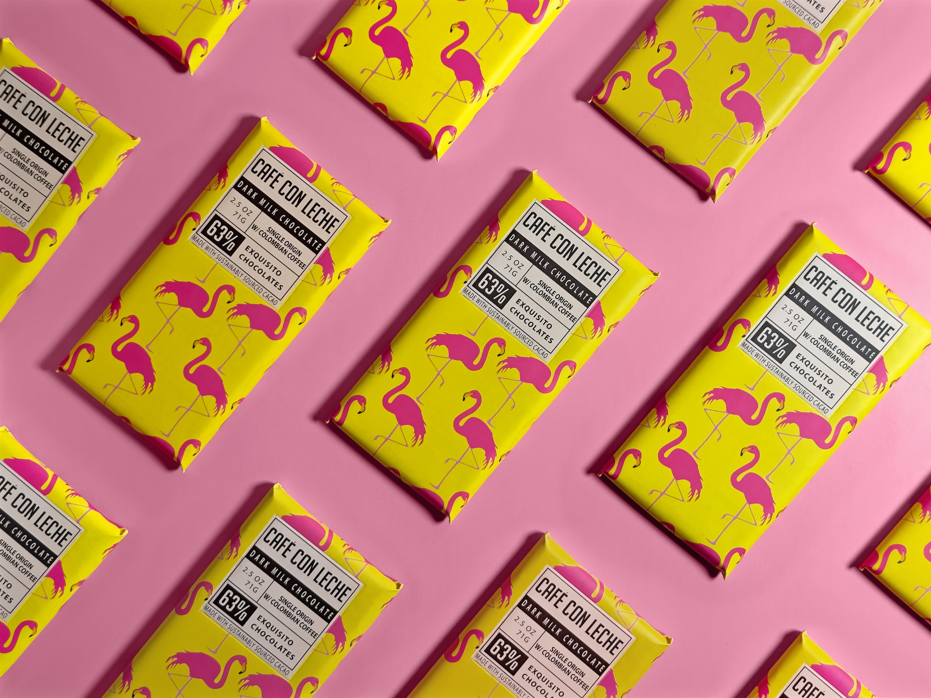 Cafe Con Leche Milk Chocolate & Per'La Coffee bar made by Exquisito Chocolates repeating on a pink background