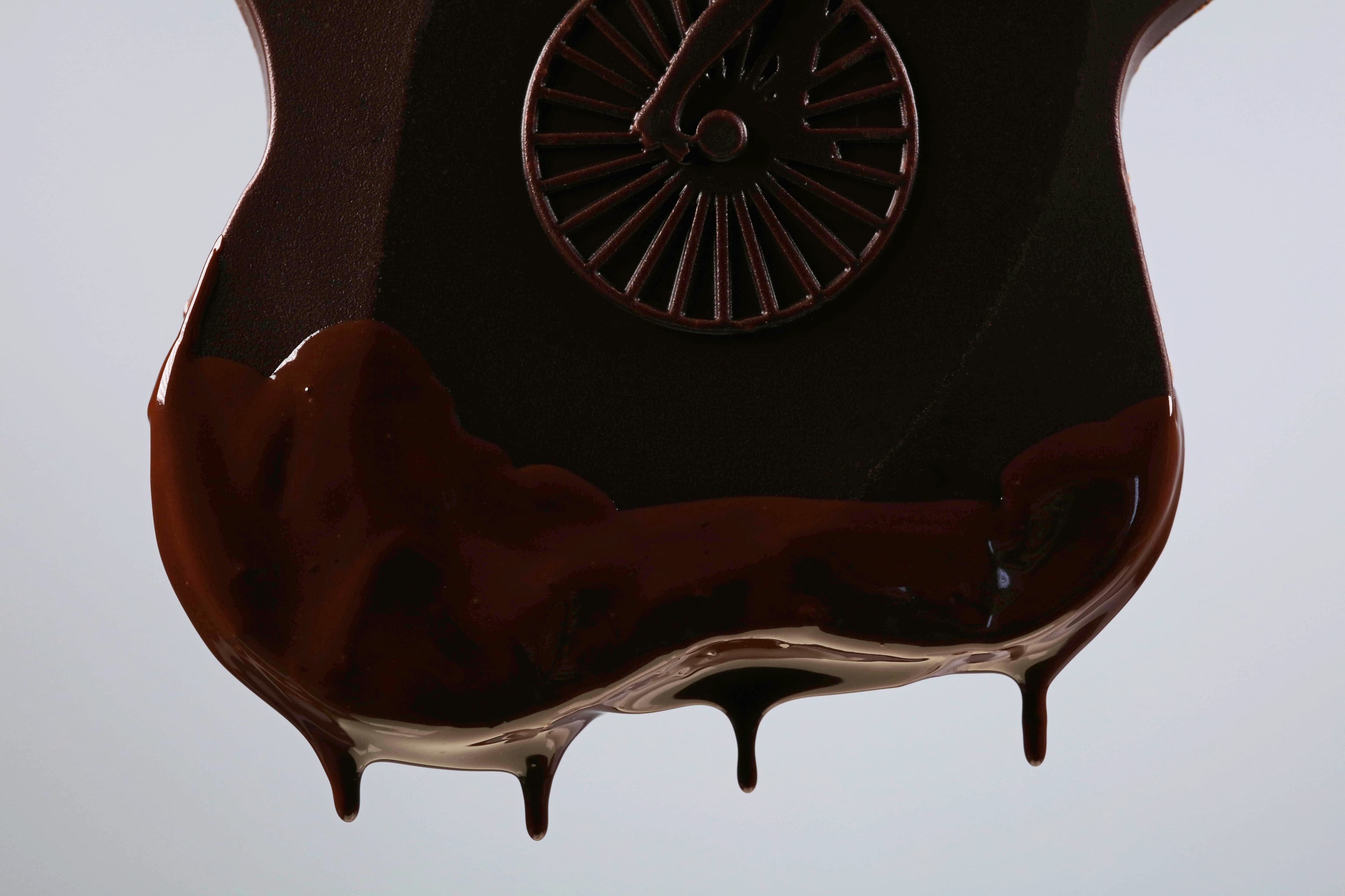 Citrus Licorice Crunch bar made by Chocolate Naive in Lithuania macro shot of bar dripping with chocolate