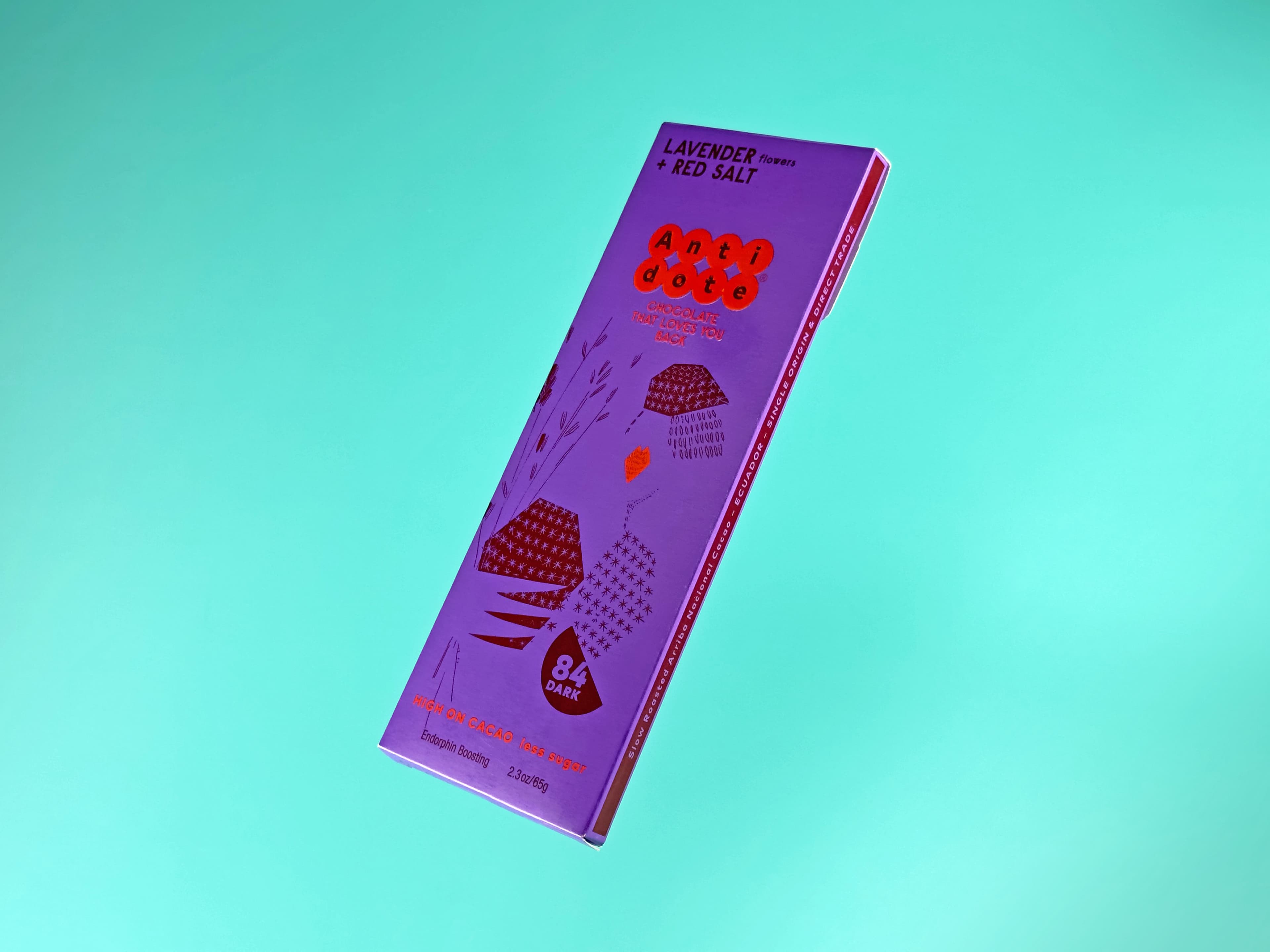 Lavender Flowers + Red Salt bar from Antidote Chocolate floating on a teal background
