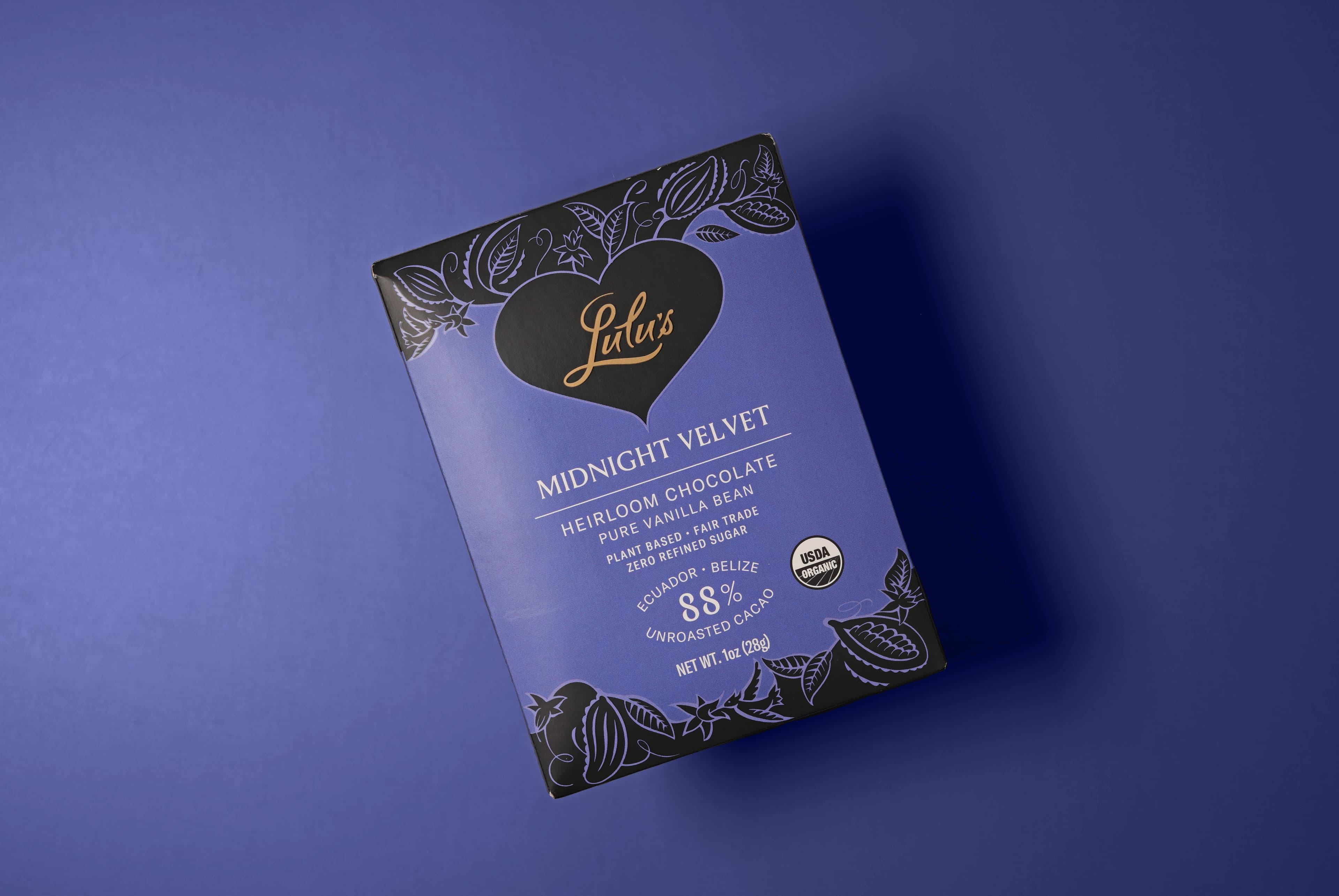 Midnight Velvet bar made by Lulu's Chocolate in the United States with on a purple background with a deep drop shadow