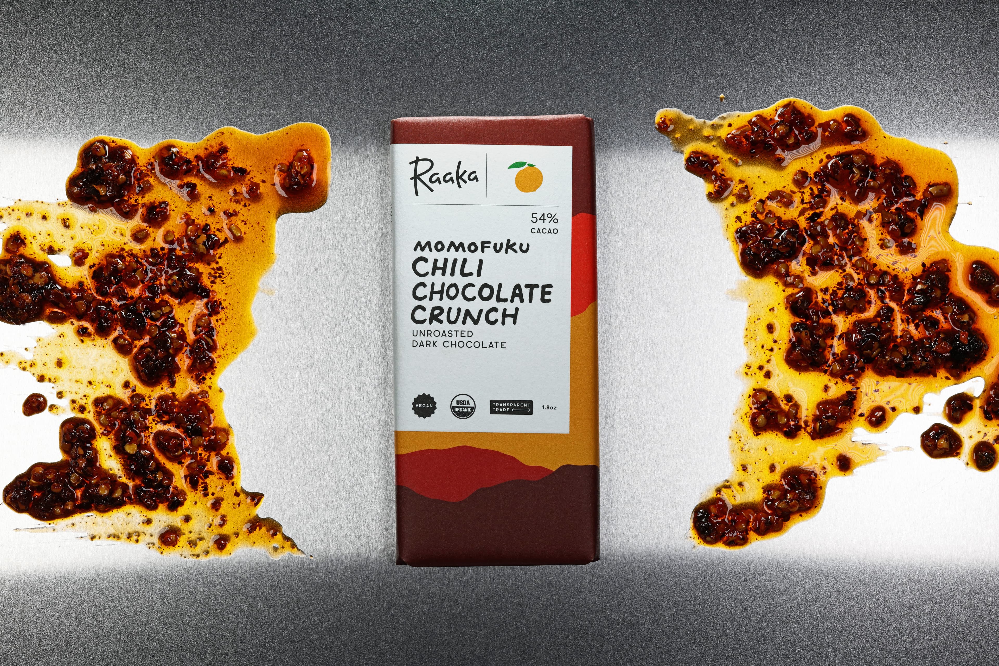 Momofuku Chili Chocolate Crunch bar made by Raaka Chocolate in the United States with swirls of chili oil around it