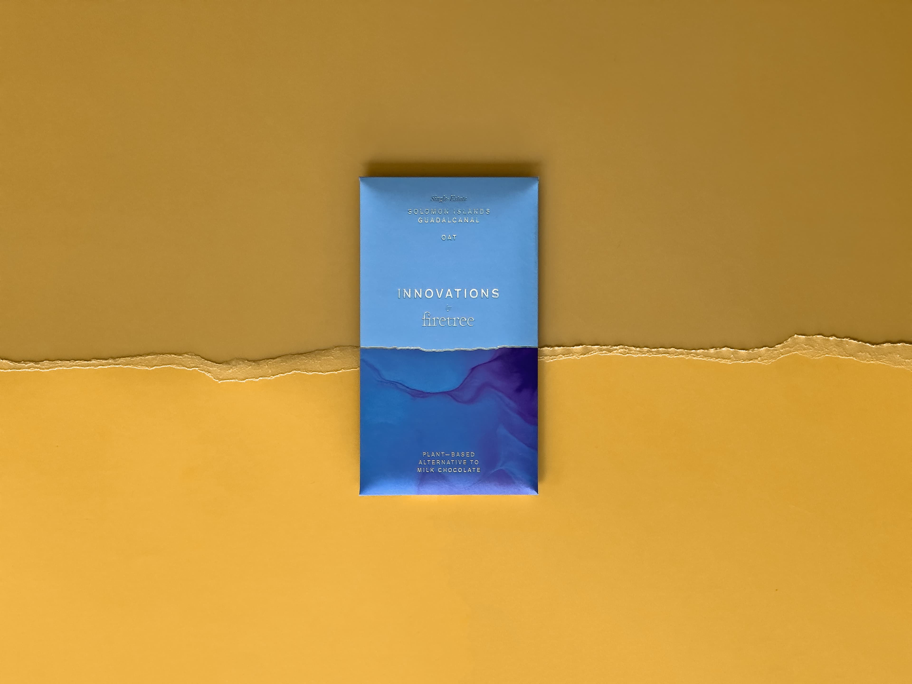 Solomon Islands, Guadalcanal Oat Milk bar made by Firetree Chocolate on a yellow background with ripped paper texture